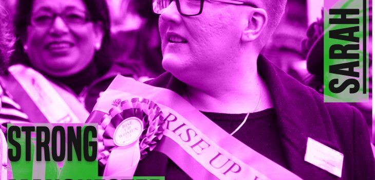The picture is a of a woman from chest height up. She has her head turned to the left. She has short hair and glasses. she is wearing a sash. The picture has a purple hue to it. On the leff of the picture are the words 'strong manchester women' on the right 'Sarah Judge' - both in capital and grey colour letters