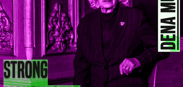 A woman with white hair sits on a chair and looks at the camera. Her right elbow leans on the back of the chair. She has her legs crossed. She is wearing a dark skirt and jacket. The photo crops just under her knees. The picture has a purple hue to it. On the leff of the picture are the words 'strong manchester women' on the right 'Dena Murphy' - both in capital and grey colour letters