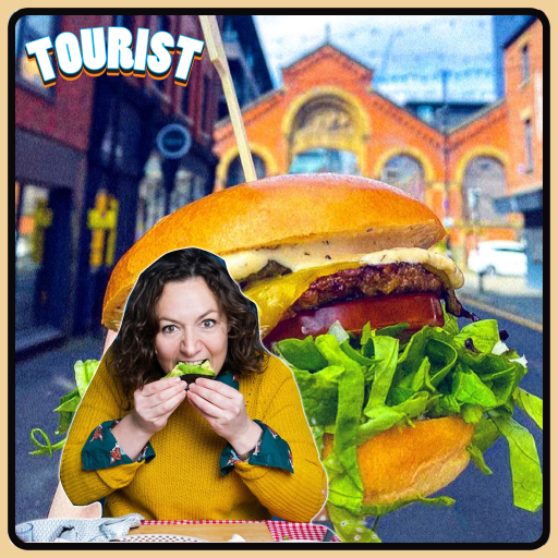 [Image of a town blurred out in the background and a large burger in the centre of the background with the podcast guest Jessica Fostekew on the left wearing a yellow knitted jumper and biting into a piece of food.]