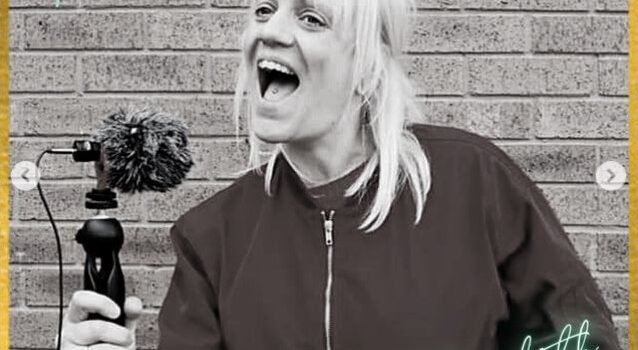 a black and white photo of a woman holding a microphone